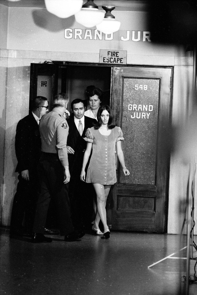 Susan Atkins leaves the grand jury room after testifying against accused murderer Charles Manson, Los Angeles, California, December 1969. The man in the suit to her right is most likely her attorney, Richard Caballero. (Photo by Ralph Crane/Time Life Pictures/Getty Images)